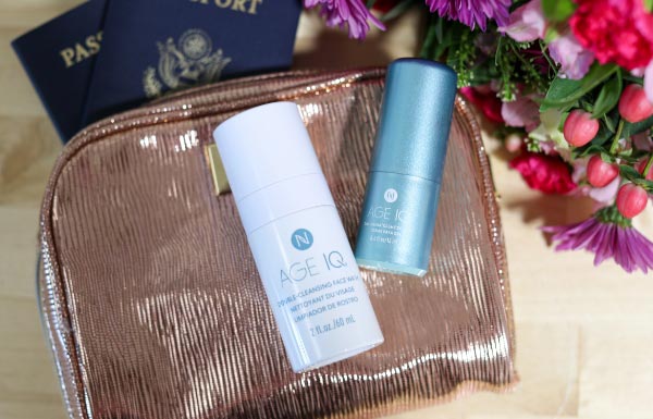 Lifestyle shot of the Age IQ Travel Minis Cleanser & Day Cream Combo bottles on top of a clear bag.